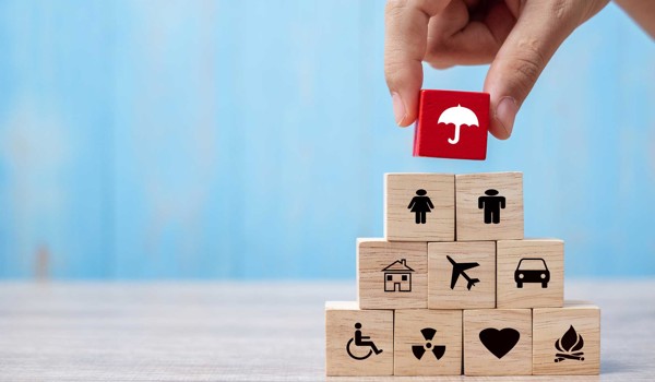 Hand Holding Umbrella Wood Block Cover Insurance Icon. Healthcare Medical, Life, Car, Home, Travel Insurance Concept